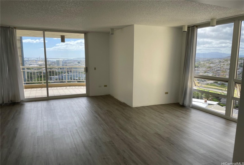 Living room with view out to the Leeward side. with dining area on the right with views out to Koolau's