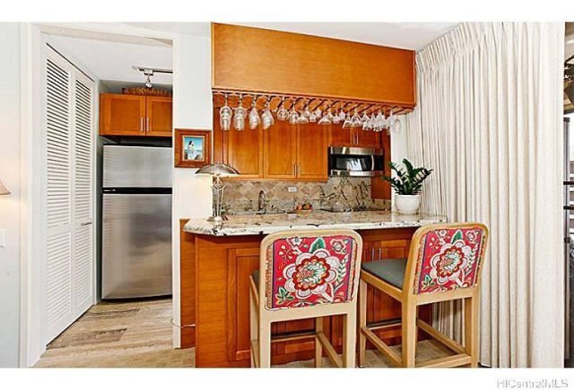 Kitchen counter bar/dining top with cabinet storage and glass rack