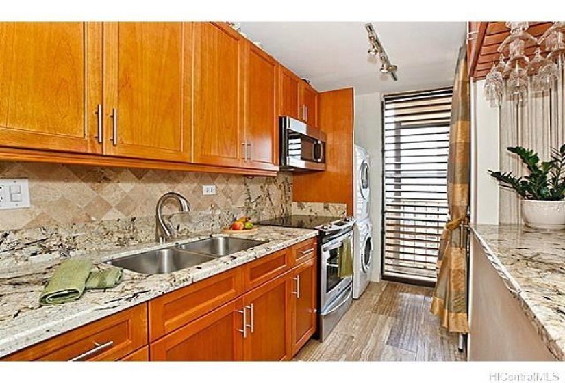 Full kitchen with stack washer and dryer