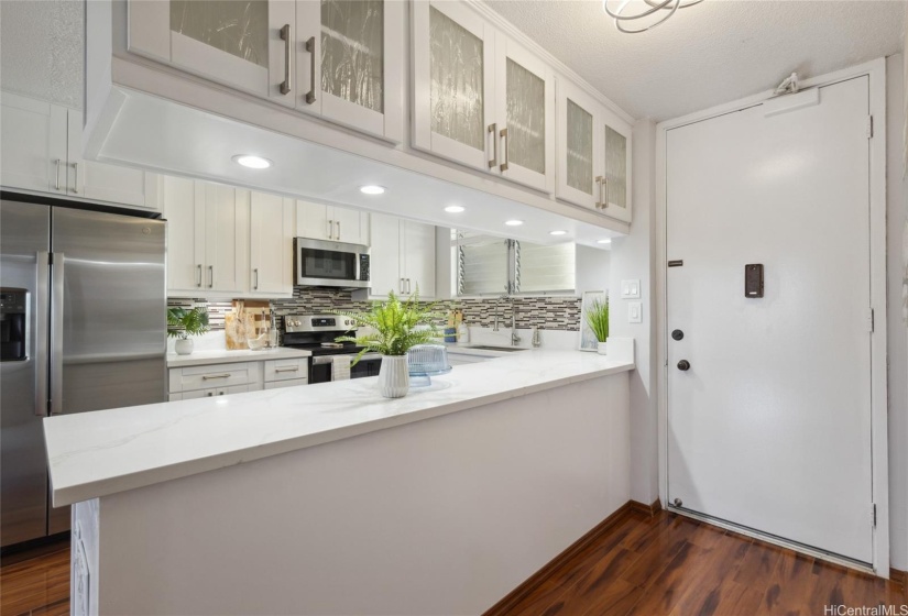 Kitchen to the right of the front door.