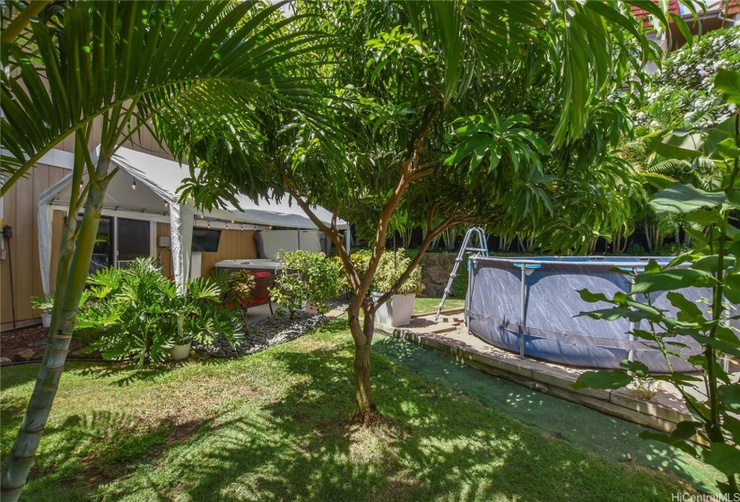 Enjoy your large yard with an above ground swimming pool or pick  sweet mangoes from your own mango tree.