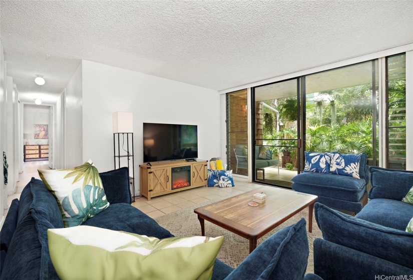 Living area facing the lanai and hallway.  Stackable washer/dryer and water heater located in hallway closet on left.