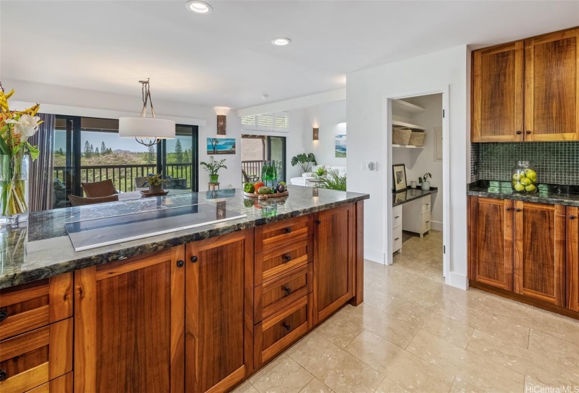 Kitchen has a walk-in pantry with ample shelf space and built-in desk