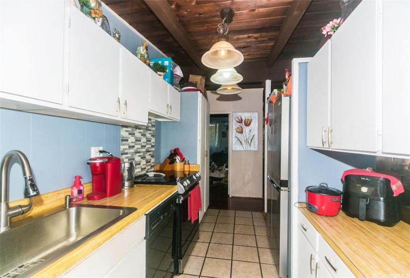 Another view of the kitchen with stainless sink/fixtures