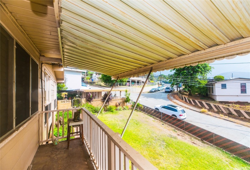 A part of the covered lanai looking toward the lawn and street beyond