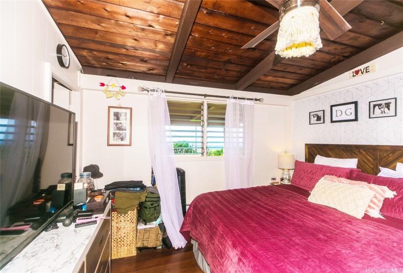 The primary bedroom with a view of the ocean