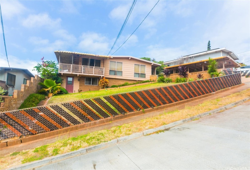 Home is situated on a hill with fencing/walls around property