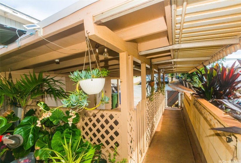 You can see the gate down the covered walkway to the street and the carport is to the left