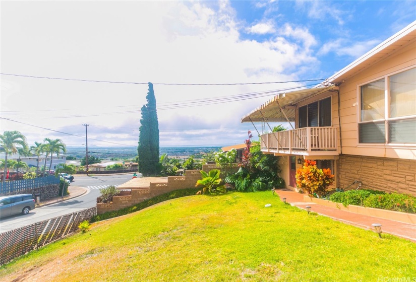 A view of the front lawn and the ocean view beyond-Yes, Diamond Head is visible