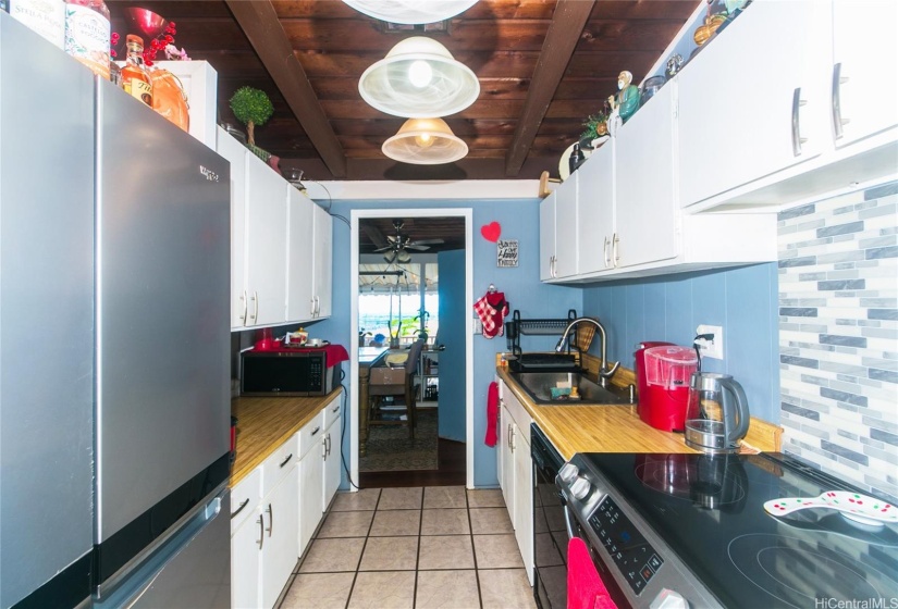 One view of the kitchen with newer range oven and newer refrigerator