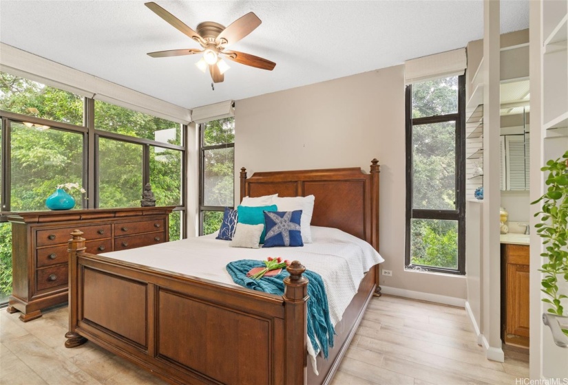 Primary bedroom w/ treetop views.