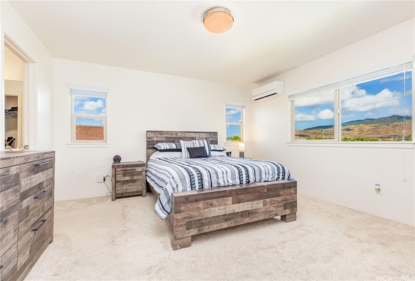 Primary bedroom with mountain and park views