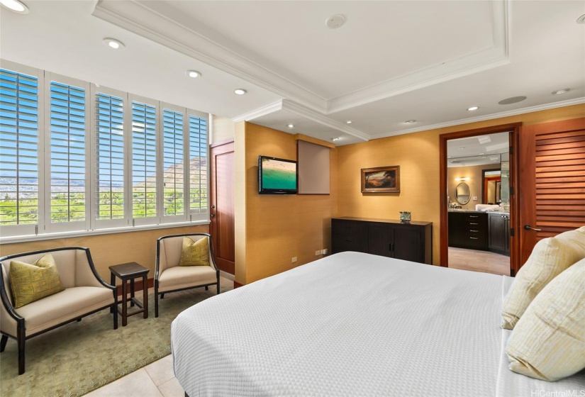 Another view of the primary suite with Diamond Head, mountain and treetop park views