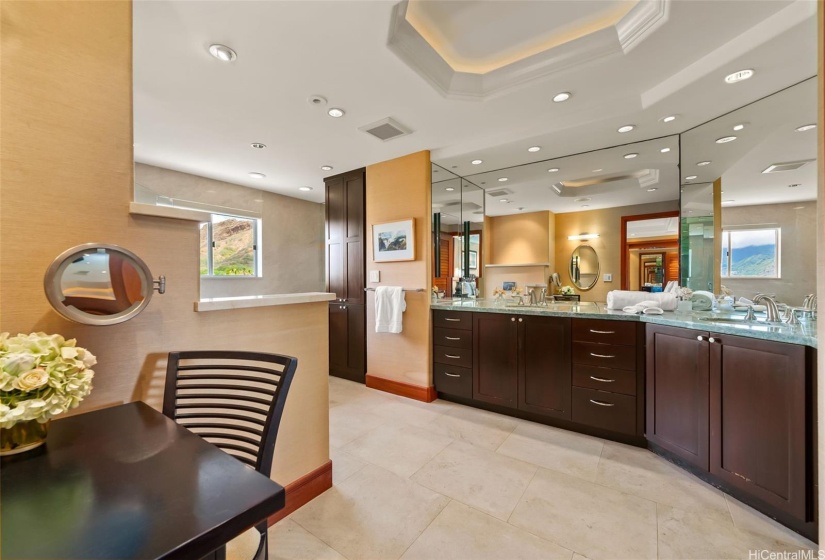 Primary bath with vanity, dual sinks, secondary closet, jetted tub and walk-in shower