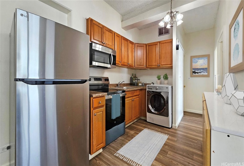 Virtually staged photo. Kitchen is updated, washer/dryer combo.