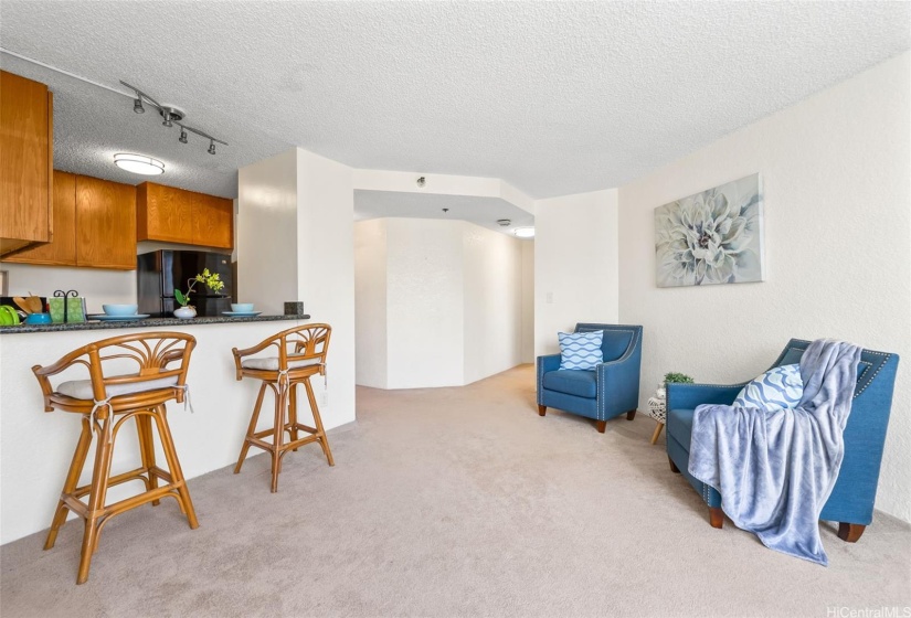 Spacious living room has a built in countertop for dining