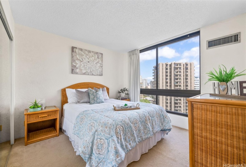 Spacious bedroom has large windows for lots of natural lighting