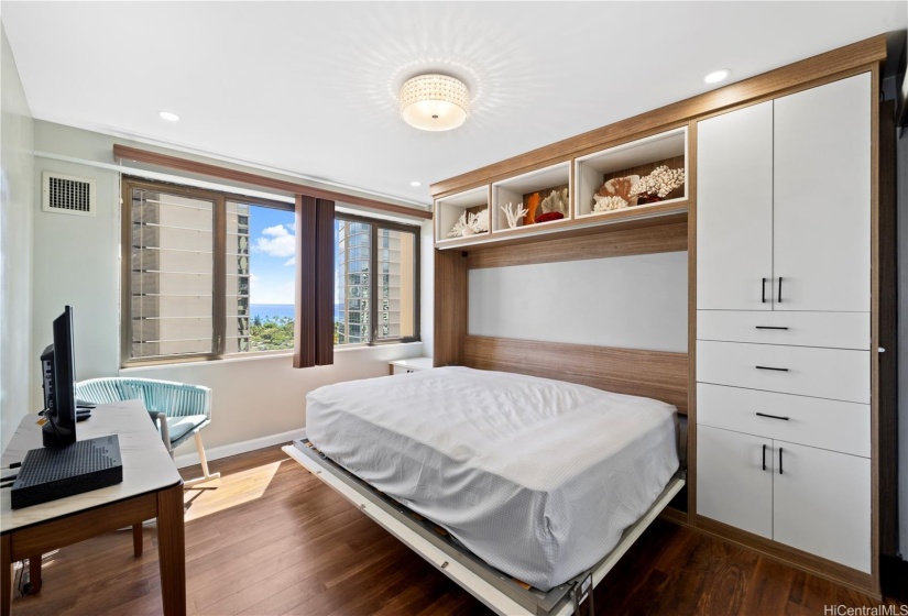 A California Closets murphy bed with cabinets on the side.