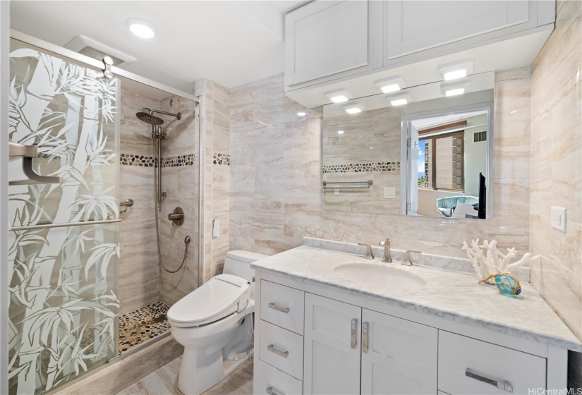 New tile in bath shower with updated flooring and vanity.