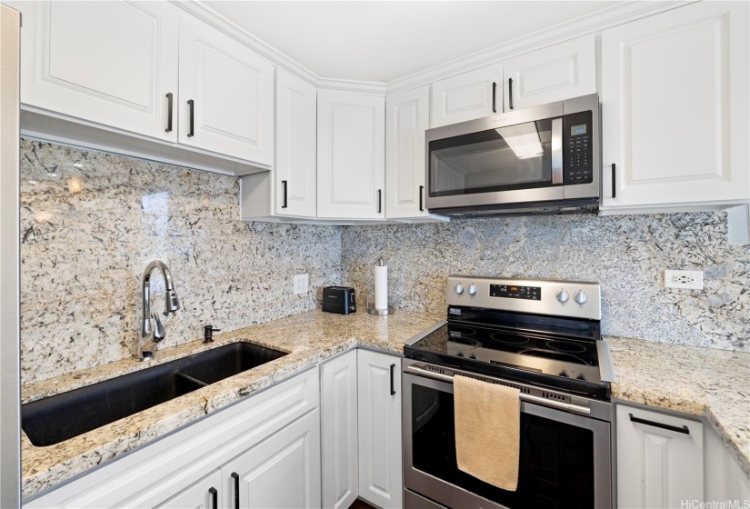 Kitchen was remodeled with quarts coutnertops, hardwood cabinets and new lighting.