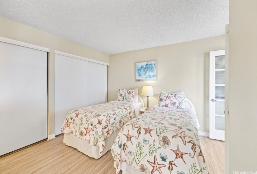 Double closets line the wall of the bedroom.