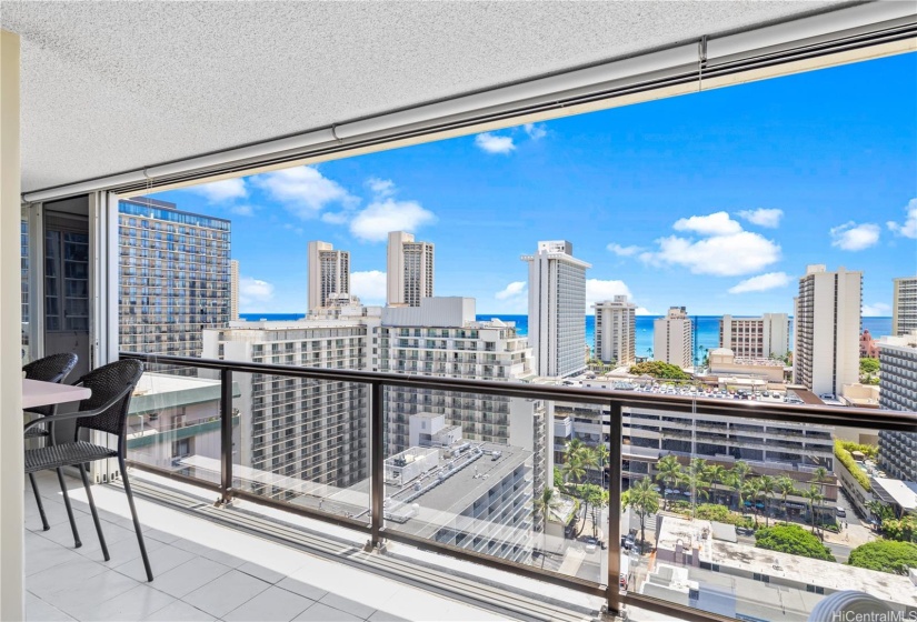 The enclosed lanai and sliding doors create a wide opening to enjoy the Waikiki skyline.