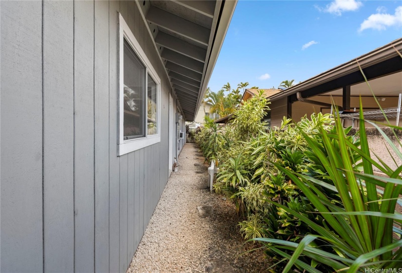 Right side of yard on the right side, concrete fenced yard