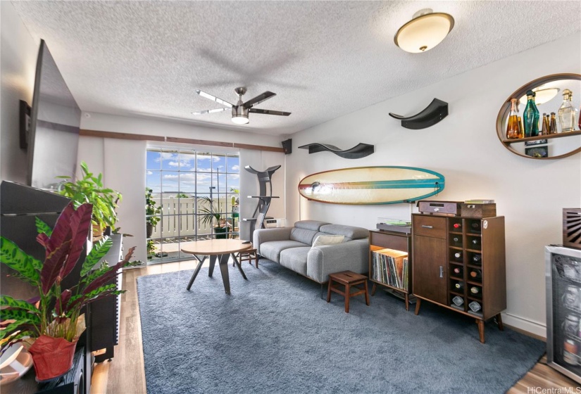 Updated flooring throughout whole unit, living room looking out towards the lanai.