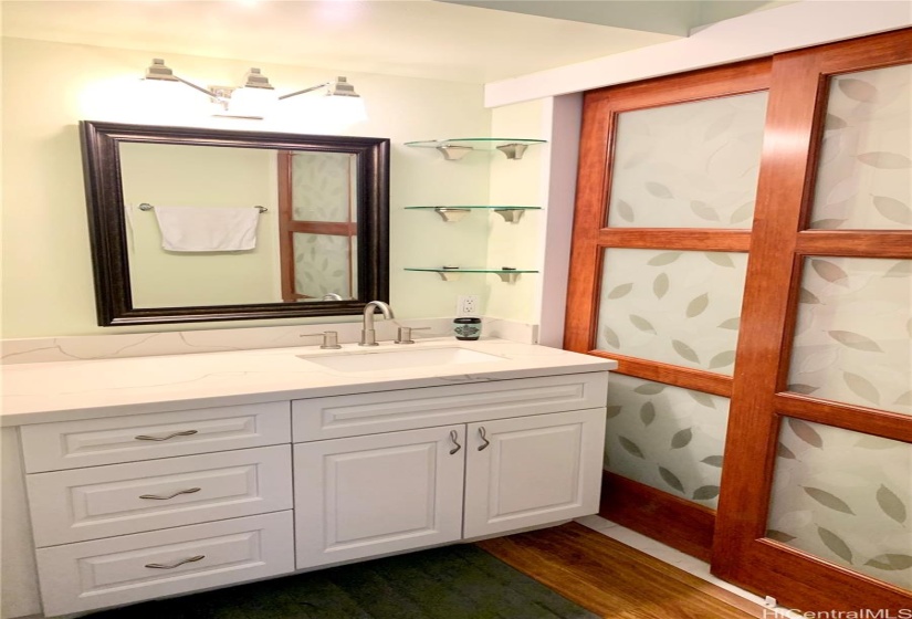 Sink area separated from toilet/shower area by glass and wood shoji doors