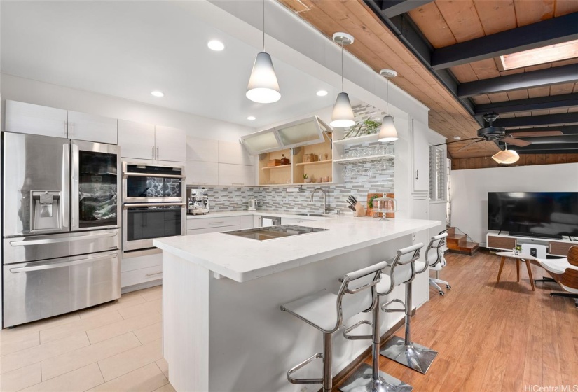 A beautifully remodeled kitchen for the chef's delight offers plenty of cabinet storage and an eat in counter for more casual dining.