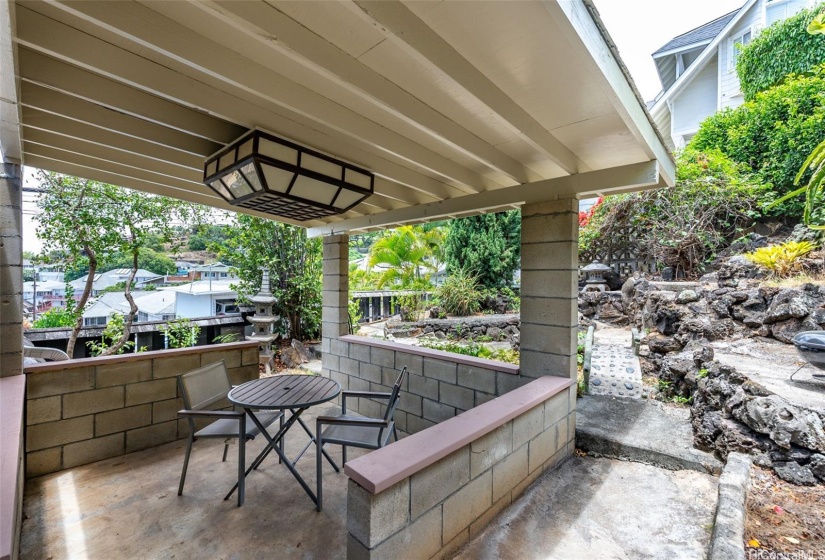 Offering wonderful outdoor spaces, this covered lanai is just off the 1/1 cottage with a ornamental garden just beyond.