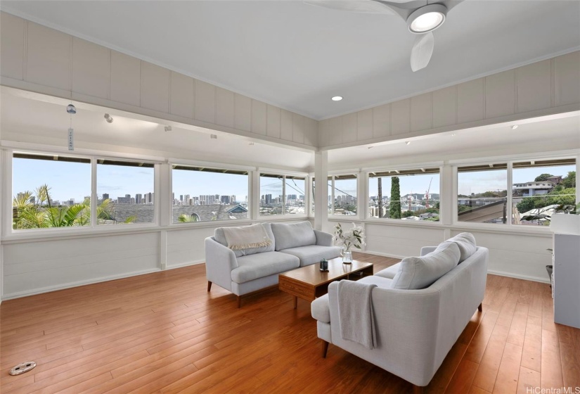 A spacious living room with split AC to stay cool year round offers amazing skyline views of Honolulu and features vinyl plank flooring and newer double pane picture windows.  Also being included are custom remote controlled window shades.