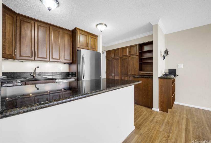 Remodeled kitchen and entry way has granite countertops.