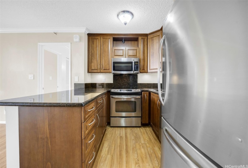 Remodeled kitchen has granite countertops.