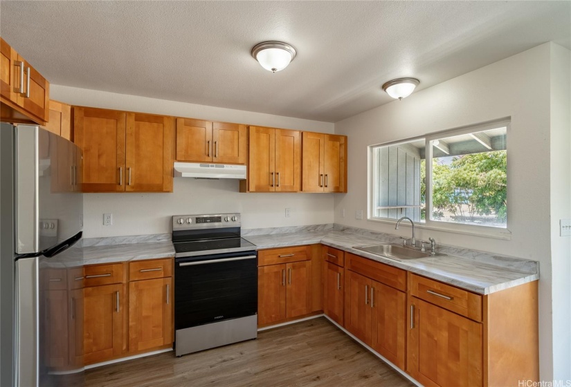 Kitchen in mauka unit (units are mirror images of each other, and both feature brand new stoves and refrigerators.)