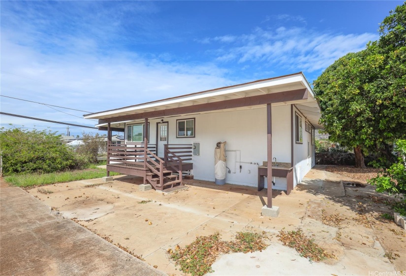 side of house, covered lanai and utility area