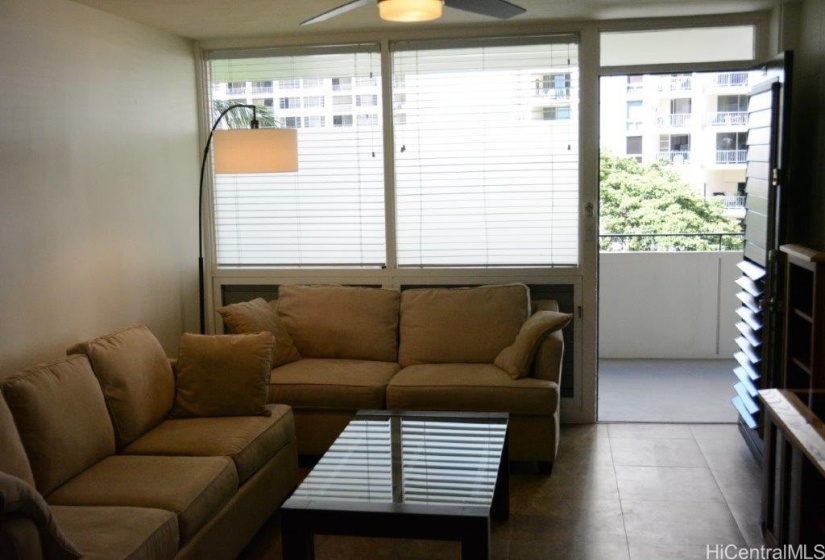 Front entrance to living room with sofa and love seat. Both let out into beds.