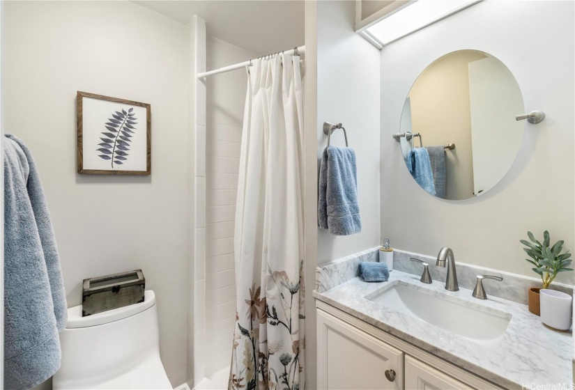 Bright and clean hallway bathroom.