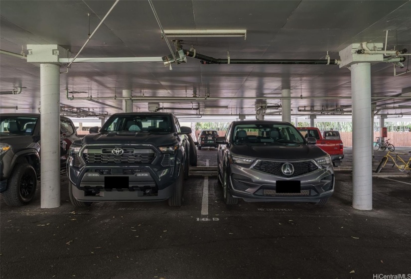 Two wide, covered side by side parking stalls close to the elevator