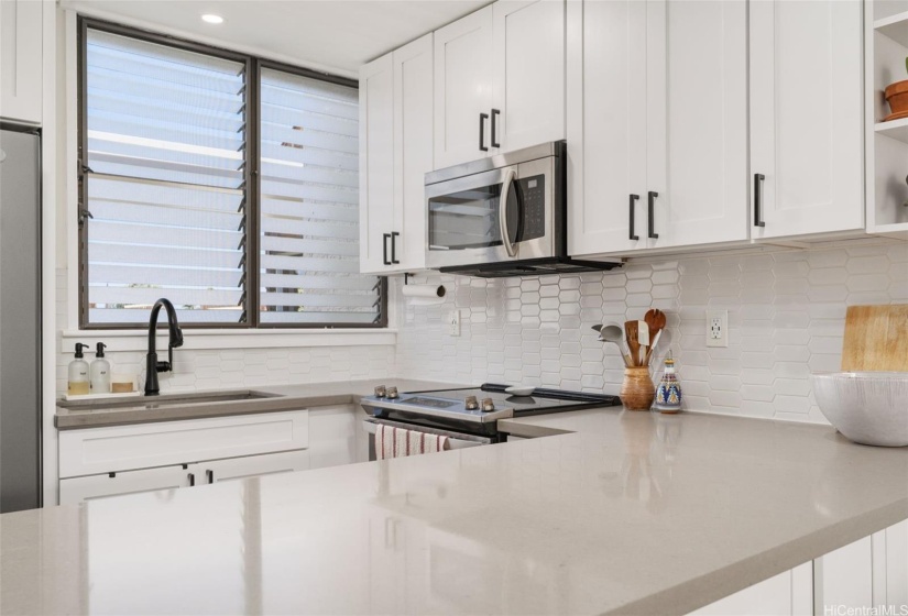 Shaker cabinets, quartz countertops and stainless steel appliances