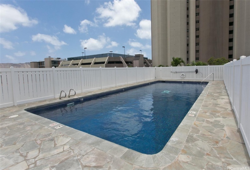 Newly renovated pool and sun deck, with bathrooms and sauna located nearby outside the pool fencing.