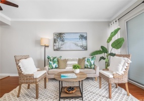 Living room with ceiling fan and lanai doors