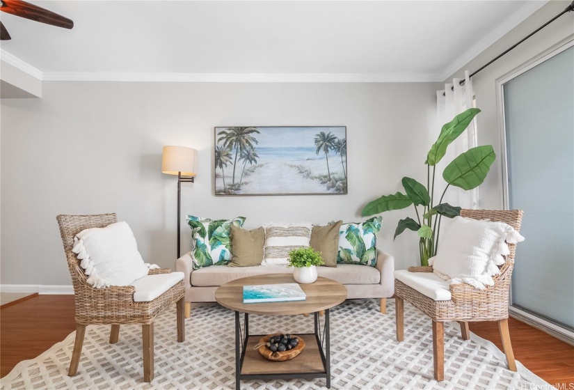 Living room with ceiling fan and lanai doors