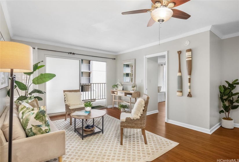 Living room with ceiling fan, lanai door and bedroom entrance