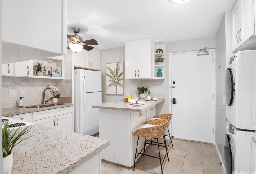 Front Door, Kitchen and stacked washer and dryer and breakfast bar.