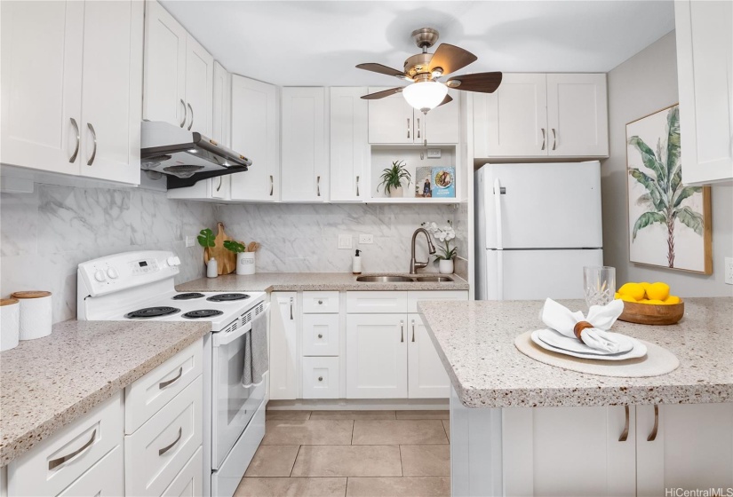 Kitchen with many cabinets and ceiling fan.