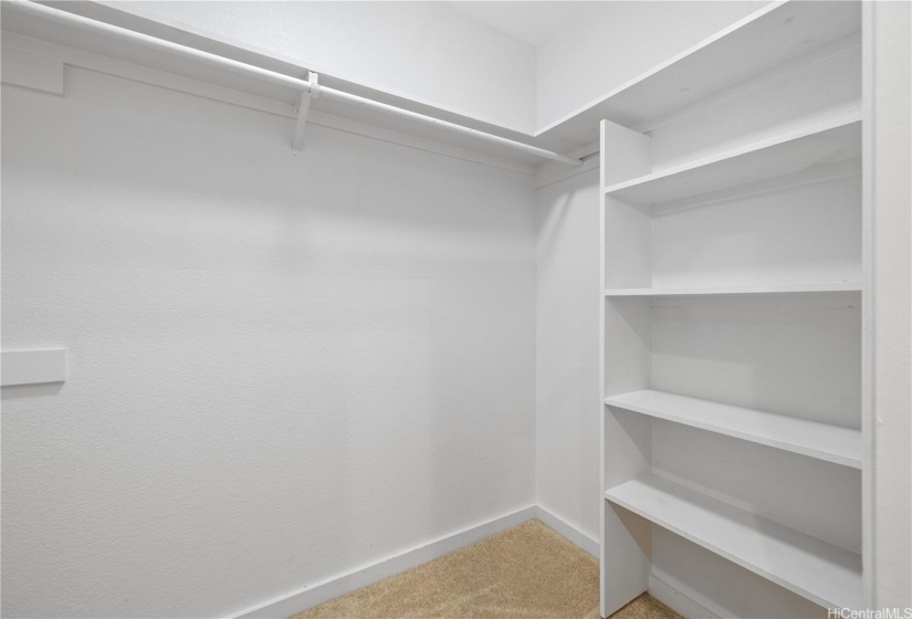 Primary bedroom walk in closet.