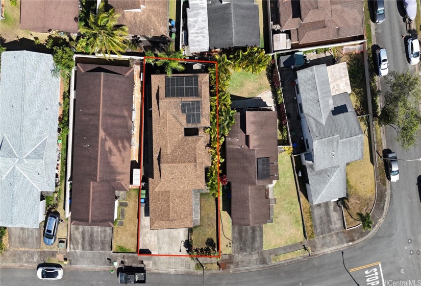 Aerial view with a glimpse of the lot outline and PV panels.