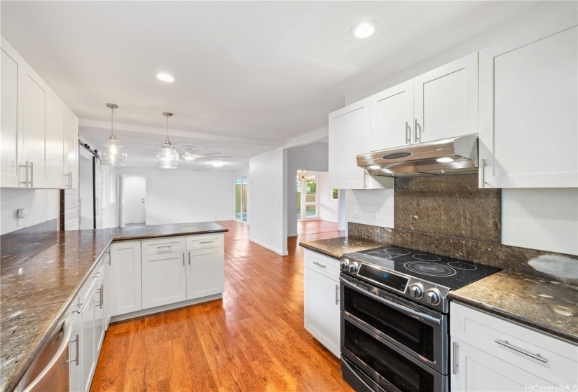 Remodeled kitchen with granite countertops and hardwood cabinets.