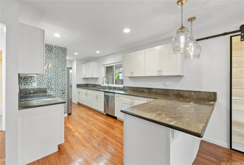 Open kitchen with countertop seating.